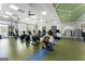 An exercise room with large windows and a variety of gym equipment at 608 White Cedar Ct, Peachtree City, GA 30269