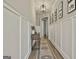 Hallway with wood floors, paneled walls, and a decorative rug that adds warmth and style to the space at 608 White Cedar Ct, Peachtree City, GA 30269