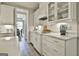 Bright kitchen featuring white cabinets, quartz countertops, and stainless steel appliances at 608 White Cedar Ct, Peachtree City, GA 30269