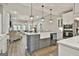 Open concept kitchen with island, stainless steel appliances, and access to living room at 608 White Cedar Ct, Peachtree City, GA 30269