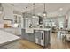 Open concept kitchen with island, stainless steel appliances, and access to living room at 608 White Cedar Ct, Peachtree City, GA 30269