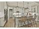 Modern kitchen island with pendant lighting and wicker chairs at 608 White Cedar Ct, Peachtree City, GA 30269
