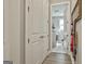 Hallway view into the laundry room with white washer and dryer appliances at 608 White Cedar Ct, Peachtree City, GA 30269