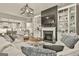 Inviting living room featuring a fireplace, built-in shelves, and an open floor plan at 608 White Cedar Ct, Peachtree City, GA 30269