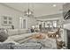 Spacious living room with an open floor plan, fireplace, and view of the modern kitchen at 608 White Cedar Ct, Peachtree City, GA 30269
