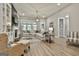 Open-concept living room with a large sectional sofa, stylish decor, and lots of natural light at 608 White Cedar Ct, Peachtree City, GA 30269