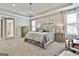 Bright main bedroom featuring a tray ceiling, gray carpet, and plenty of natural light at 608 White Cedar Ct, Peachtree City, GA 30269