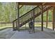 Under deck outdoor space with grill and staircase to backyard at 608 White Cedar Ct, Peachtree City, GA 30269