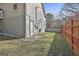 Nice backyard with green lawn, partial fence, and mature trees at 100 Rockland Trl, Sharpsburg, GA 30277