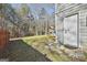 View of a well-maintained backyard with lush green lawn and mature trees at 100 Rockland Trl, Sharpsburg, GA 30277