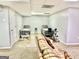 View of a well-lit basement featuring tile flooring and space for recreational activities at 100 Rockland Trl, Sharpsburg, GA 30277
