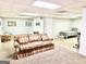 Finished basement with areas for lounging and playing at 100 Rockland Trl, Sharpsburg, GA 30277