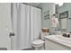 Clean bathroom features a shower with curtain and white vanity at 100 Rockland Trl, Sharpsburg, GA 30277