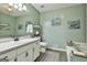 Calming bathroom with white vanity, large mirror, and tub with tile surround at 100 Rockland Trl, Sharpsburg, GA 30277