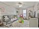 Charming bedroom features a colorful rug and whitewashed wood accent wall at 100 Rockland Trl, Sharpsburg, GA 30277