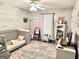 Charming bedroom features a colorful rug and whitewashed wood accent wall at 100 Rockland Trl, Sharpsburg, GA 30277