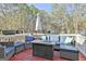 Outdoor deck with comfortable seating area and patio umbrella at 100 Rockland Trl, Sharpsburg, GA 30277
