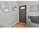 Cozy entryway featuring a decorative wreath on a wooden door and neutral gray walls at 100 Rockland Trl, Sharpsburg, GA 30277