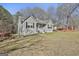Traditional ranch-style home with a well-manicured lawn and an inviting front porch and neutral gray exterior at 100 Rockland Trl, Sharpsburg, GA 30277