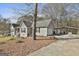Exterior view of home with driveway, garage, carport, and well-kept lawn and landscaping at 100 Rockland Trl, Sharpsburg, GA 30277