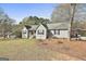 Ranch-style home with light gray exterior, complemented by a carport and well-maintained landscaping at 100 Rockland Trl, Sharpsburg, GA 30277