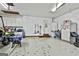 Spacious garage featuring white cabinets, ample storage, and space for vehicle and tool organization at 100 Rockland Trl, Sharpsburg, GA 30277