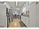 Open-concept kitchen with stainless steel appliances, white cabinetry, and seamless flow to dining area at 100 Rockland Trl, Sharpsburg, GA 30277