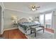 Spacious main bedroom featuring a ceiling fan and a decorative bed frame at 100 Rockland Trl, Sharpsburg, GA 30277