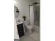 The bathroom has a modern vanity, round mirror, new shower and white marble floors at 349 Saratoga Pl, Riverdale, GA 30296