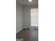 Bedroom featuring natural light from the window with modern blinds and light wood-look floors at 349 Saratoga Pl, Riverdale, GA 30296