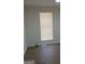 Bedroom with natural light from the window with modern blinds and light wood-look floors at 349 Saratoga Pl, Riverdale, GA 30296