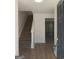 Inviting entryway with stairs and views into a large open living area with new flooring at 349 Saratoga Pl, Riverdale, GA 30296