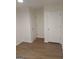 Hallway featuring clean white doors, modern baseboards, and light wood-look floors at 349 Saratoga Pl, Riverdale, GA 30296