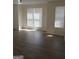 This living room has new flooring, lots of natural light, and a ceiling fan at 349 Saratoga Pl, Riverdale, GA 30296