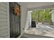 Covered section of back deck with grill and side door at 225 Mapledale Trl, Sharpsburg, GA 30277