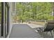 Relax on the back deck with a view of a wooded back yard at 225 Mapledale Trl, Sharpsburg, GA 30277
