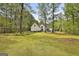 Expansive backyard with lush lawn and fencing, providing a private outdoor space at 225 Mapledale Trl, Sharpsburg, GA 30277