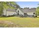 Backyard showcasing a spacious deck and lush lawn, great for outdoor entertaining at 225 Mapledale Trl, Sharpsburg, GA 30277