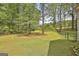 Expansive backyard featuring well-maintained lawn and mature trees at 225 Mapledale Trl, Sharpsburg, GA 30277