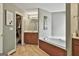 Bathroom with a walk-in closet, soaking tub, and vanity with ample counter space at 225 Mapledale Trl, Sharpsburg, GA 30277