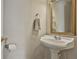 Powder room featuring a pedestal sink with a decorative mirror and towel rack at 225 Mapledale Trl, Sharpsburg, GA 30277