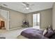 Comfortable bedroom with neutral carpet, ceiling fan and study nook at 225 Mapledale Trl, Sharpsburg, GA 30277