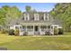 Charming home with a welcoming front porch, dormer windows and a well-manicured lawn at 225 Mapledale Trl, Sharpsburg, GA 30277