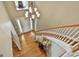 Bright foyer features hardwood floors, white trim staircase, and a modern chandelier at 225 Mapledale Trl, Sharpsburg, GA 30277