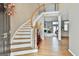 Elegant foyer with hardwood floors, a curved staircase, and views into the spacious living room at 225 Mapledale Trl, Sharpsburg, GA 30277