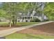 Charming home with a welcoming front porch, well-manicured lawn, and an inviting driveway at 225 Mapledale Trl, Sharpsburg, GA 30277