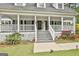 Inviting front porch with a decorative door and stylish railing, enhanced by colorful flowers at 225 Mapledale Trl, Sharpsburg, GA 30277