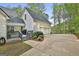 Attached garage and outdoor area with landscaping and a fenced-in entrance at 225 Mapledale Trl, Sharpsburg, GA 30277