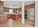 Kitchen featuring wooden cabinets, an island, stainless steel appliances and neutral countertops at 225 Mapledale Trl, Sharpsburg, GA 30277