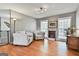 Comfortable living room with hardwood floors, a faux fireplace, and plenty of natural light from the many windows at 225 Mapledale Trl, Sharpsburg, GA 30277